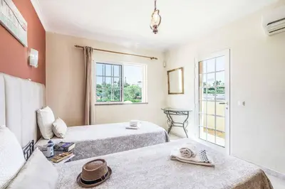 a room with two beds and a window at Villa Judite in Albufeira