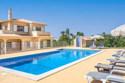 a swimming pool in front of a villa at Villa Judite in Albufeira