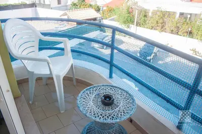 a balcony with two chairs and a swimming pool at Apartamentos Sereia da Oura in Albufeira