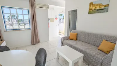 a living room with a couch and a table at Apartamentos Sereia da Oura in Albufeira