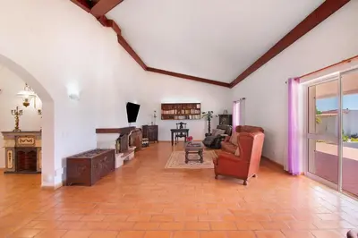 a living room with a piano and a living room with furniture at Monte do Pataco in Albufeira