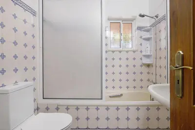 a bathroom with a white toilet and a sink at Monte do Pataco in Albufeira