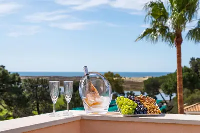a plate of fruit and wine glasses on a ledge at Extraordinary Villa on an elevated position in Quinta do Lago in Quinta do Lago