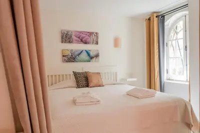 a bedroom with a bed with two towels on it at Old Village Vilamoura in Quarteira