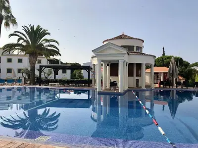 a swimming pool with a house and a building at Old Village Vilamoura in Quarteira