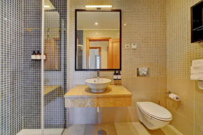 a white kitchen with white cabinets and appliances at The Prime @ The Residences Vilamoura in Quarteira