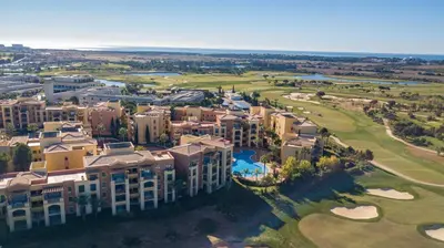 an aerial view of a resort pool with palm trees at The Prime @ The Residences Vilamoura in Quarteira