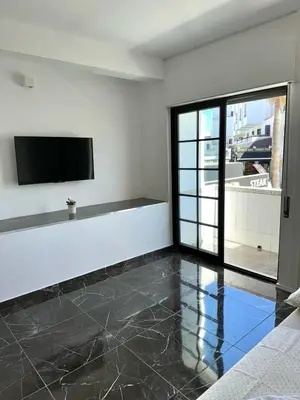a living room with a flat screen tv on a wall at Flat Luxuous Praia da Oura in Albufeira