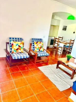 a living room with two chairs and a table at Resort Albufeira T1, Praia da Oura in Albufeira