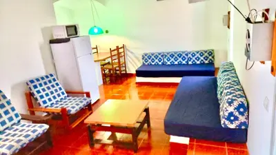 a living room with a couch and chairs and a table at Resort Albufeira T1, Praia da Oura in Albufeira