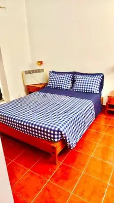 a bed in a room with a red floor at Resort Albufeira T1, Praia da Oura in Albufeira