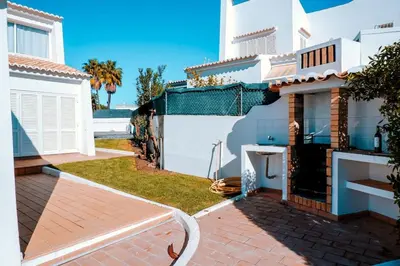 a backyard of a house with a hose at Villa Coelha - Algarve's Pearl in Albufeira
