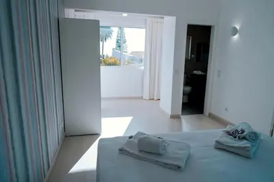 a bedroom with a bed with two towels on it at Villa Coelha - Algarve's Pearl in Albufeira