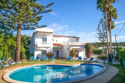 a villa with a swimming pool in front of a house at Villa dos Sonhos - Wide Dreams in Albufeira