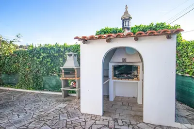 a small white building with a bell tower at Villa dos Sonhos - Wide Dreams in Albufeira