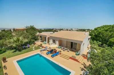 an aerial view of a house with a swimming pool at Villa Cerrinho in Albufeira