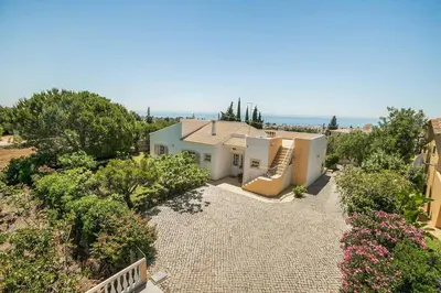 an aerial view of a house with trees and bushes at Villa Cerrinho in Albufeira
