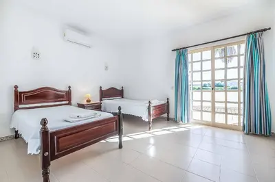 a bedroom with a bed in a white room at Villa Natalia Sun in Albufeira