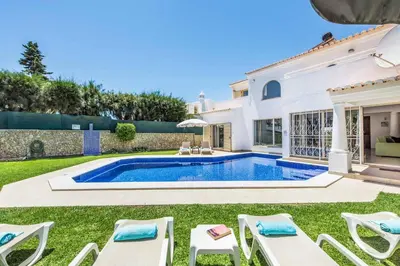 a villa with a swimming pool and lawn at Villa Tilia in Galé