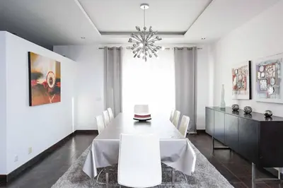 a dining room with a table and a chandelier at Villa Dala in Albufeira