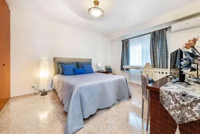 a bedroom with a bed with blue pillows at Casa Oliveira in Albufeira