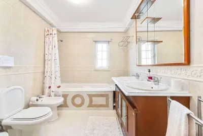 a bathroom with a sink and a toilet and a tub at Casa Oliveira in Albufeira