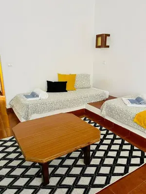a living room with two beds and a coffee table at Resort Albufeira T1, Praia da Oura in Albufeira