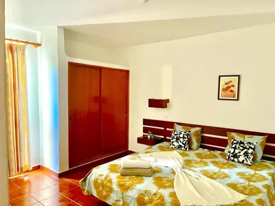 a bedroom with a bed and a red door at Resort Albufeira T1, Praia da Oura in Albufeira
