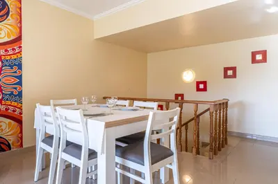 a dining room with a white table and chairs at Blue Horizon Apartment by HelloVacations in Albufeira