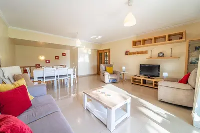 a living room with a couch and a table at Blue Horizon Apartment by HelloVacations in Albufeira