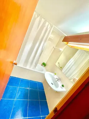 a bathroom with a white sink and a mirror at Resort Albufeira T1, Praia da Oura in Albufeira