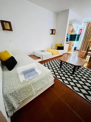 a living room with two beds and a coffee table at Resort Albufeira T1, Praia da Oura in Albufeira