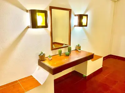 a bathroom with a sink and a mirror on a wall at Resort Albufeira T1, Praia da Oura in Albufeira