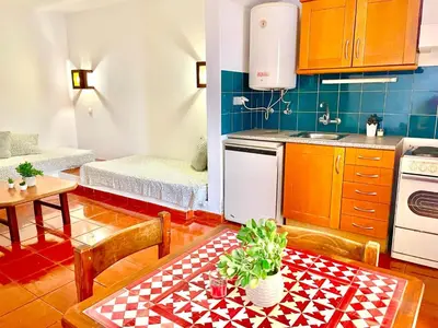 a kitchen with a table and chairs and a kitchen with a table and a kitchen at Resort Albufeira T1, Praia da Oura in Albufeira