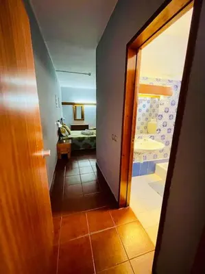 a hallway leading to a room with a bedroom at Resort Albufeira T2, Praia da Oura in Albufeira