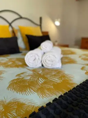 two white towels on top of a bed at Resort Albufeira T2, Praia da Oura in Albufeira