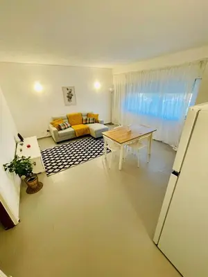 a living room with a table and a couch at Apartament Two bedrooms Praia de Quarteira in Vilamoura