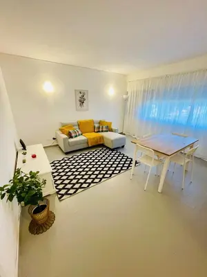 a living room with a couch and a table at Apartament Two bedrooms Praia de Quarteira in Vilamoura