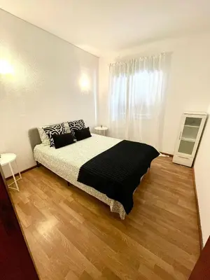 a bedroom with a bed and a wooden floor at Apartament Two bedrooms Praia de Quarteira in Vilamoura