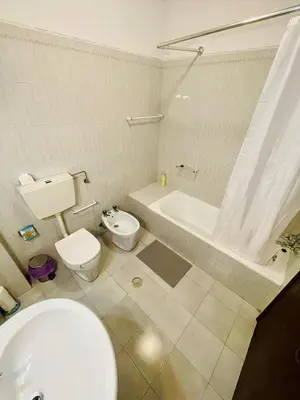 a bathroom with a toilet and a tub and a sink at Amazing Studio Flat Albufeira in Albufeira