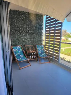 two chairs and a table on a balcony at The Albufeira Concierge - Prime Sunset Design in Albufeira