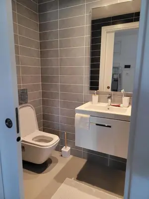 a bathroom with a toilet and a sink and a mirror at The Albufeira Concierge - Prime Sunset Design in Albufeira