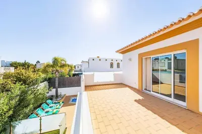 a balcony with a view of a house at Villa Astro in Albufeira