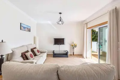 a living room with a couch and a television at Villa Astro in Albufeira