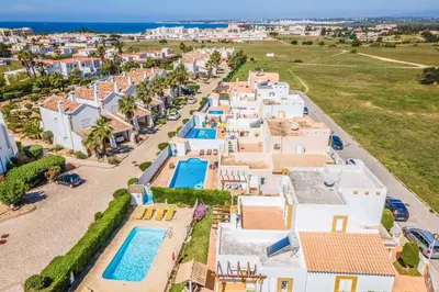an aerial view of a house with a swimming pool at Villa Ninos in Albufeira
