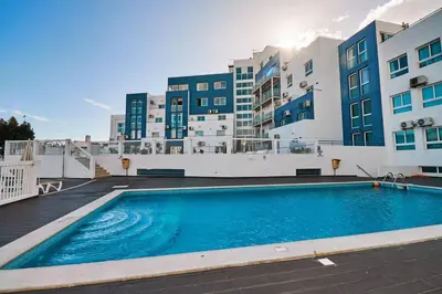 a large swimming pool in front of a building at Apartment Bay View Andrea mit Meerblick und Pool in Albufeira