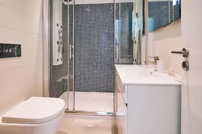 a bathroom with a shower and a toilet and a sink at Apartment Bay View Andrea mit Meerblick und Pool in Albufeira