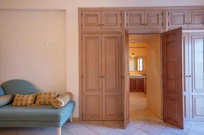 a living room with a blue couch and a closet at Al Meida Guesthouse in Albufeira