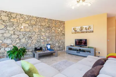 a living room with a stone wall at Casa Salir in Salir