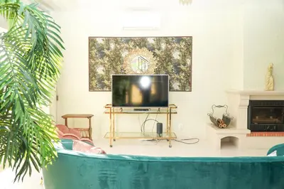 a living room with a couch and a television at Seaside Serenity Villa in Albufeira